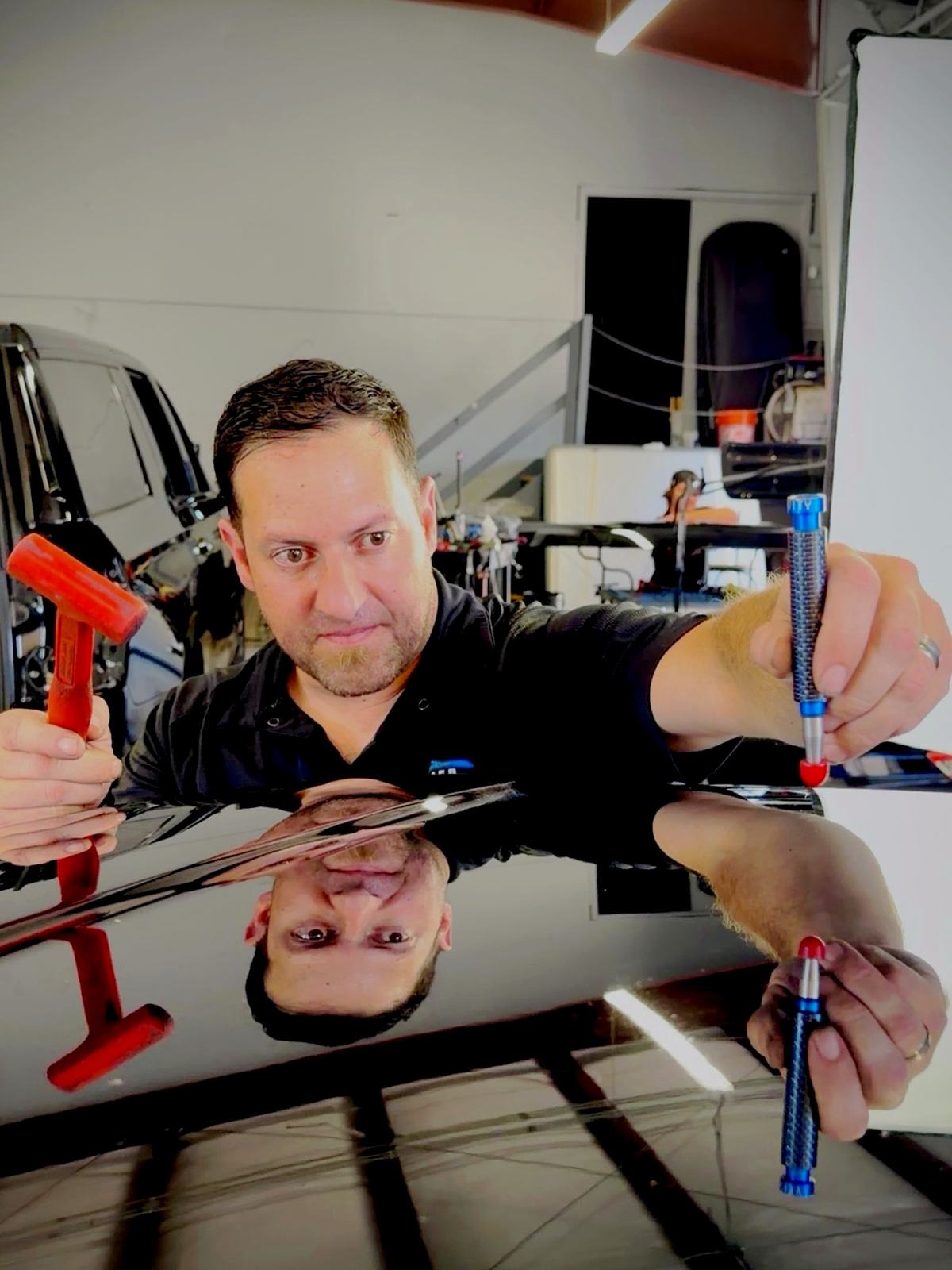 Jake Durfee owner of Certified Hail and Dent Colorado Springs with paintless dent repair tools